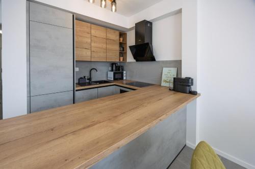 a kitchen with a wooden counter top in a room at NU Sea View in Podstrana
