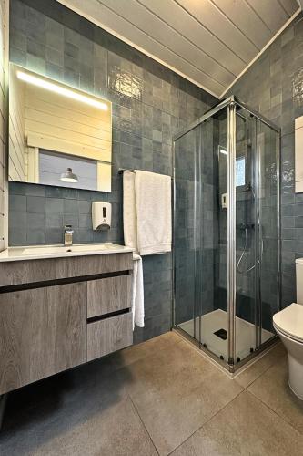 a bathroom with a shower and a sink and a toilet at Ericeira Camping in Ericeira