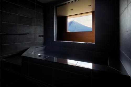 a bathroom with a window with a view of a mountain at SANGA Nature Fujinomiya in Fujinomiya