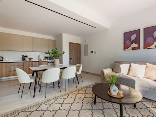 a living room with a couch and a table at Sanders Breeze Limassol in Limassol