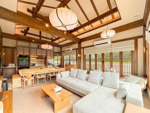 a living room with a couch and a table at Krajokkaew Inyeon Khao Yai in Ban Khlong Yang