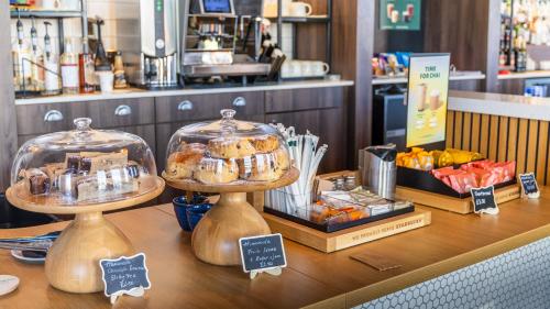 a bakery with two tiers of pastries on a counter at Holiday Inn Sunderland - City Centre by IHG in Sunderland