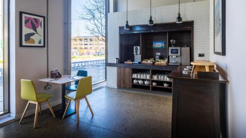 a restaurant with a table and chairs and a counter at Holiday Inn Sunderland - City Centre by IHG in Sunderland