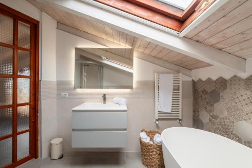 a bathroom with a sink and a mirror at Beachfront villa with direct access -Private pool & Zen Area in Quartu SantʼElena