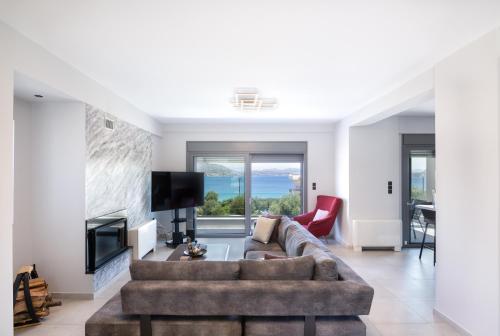 a living room with a couch and a tv at marYsol luxury maison in Eantio