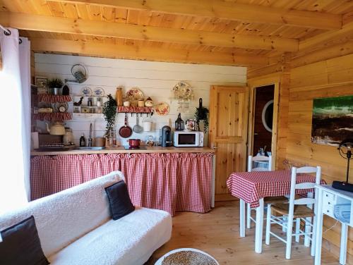 a living room with a couch and a kitchen at Chalet du bonheur 