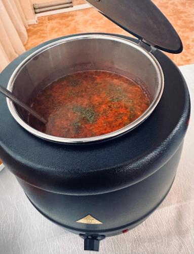 a pot of soup in a pan on a stove at Перлина Карпат in Pistyn