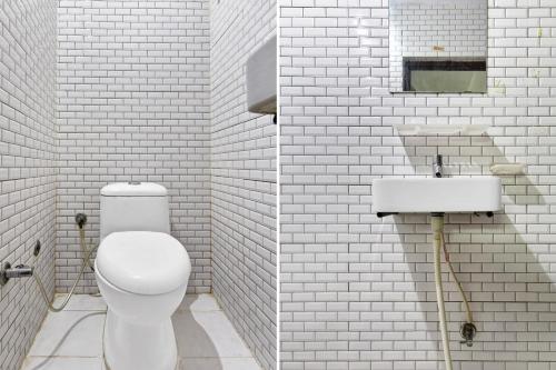 a white bathroom with a toilet and a sink at Hotel O Eleven Hotel & Banquet in Kota