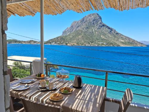 a table with food and a view of the ocean at Aegean Whisper in Masouri