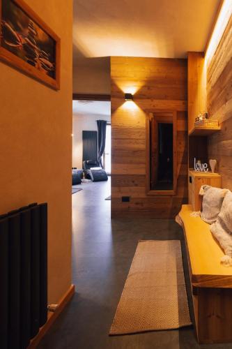 a living room with wooden walls and a yellow couch at Hotel Valle Pesio Ristorante in Chiusa di Pesio