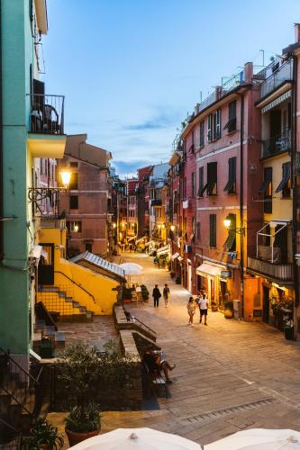 a city street with people walking down a street at Scarlet in Vernazza