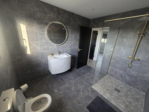 a bathroom with a sink and a toilet and a shower at Collooney - House - Sleeps 6 - Parking in Sligo