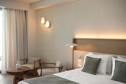 a hotel room with a bed and a table at Avra Imperial Hotel in Kolymvari
