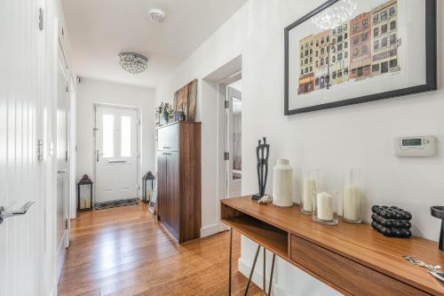a kitchen with white walls and a wooden table with candles at Royal Windsor Manor House in Windsor