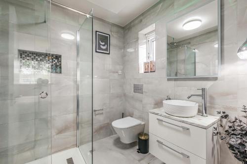 a bathroom with a shower and a toilet and a sink at Royal Windsor Manor House in Windsor