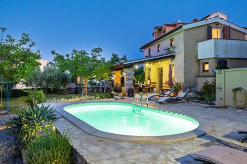 a swimming pool in the yard of a house at Villa Ivona with pool in Poljica