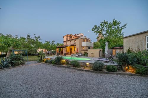 a house with a swimming pool in a yard at Villa Ivona with pool in Poljica