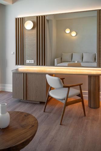 a room with a desk and a chair and a bed at Avra Imperial Hotel in Kolymvari