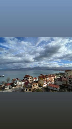 a view of a city with houses and the ocean at Hotel Belvedere in Pogradec