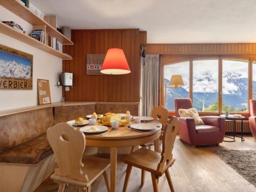 a living room with a table and chairs and a couch at Apartment La Toura by Interhome in Verbier