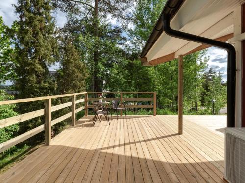 a large wooden deck with a table on it at Chalet Harge Sörgård by Interhome in Hammar