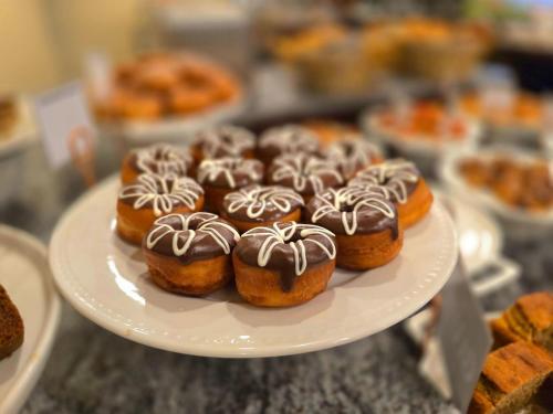 a plate of chocolate covered donuts on a counter at Best Western Premier Dynasty in Addis Ababa