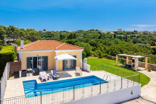 a villa with a swimming pool and a house at Europe Villa Io in Fokáta