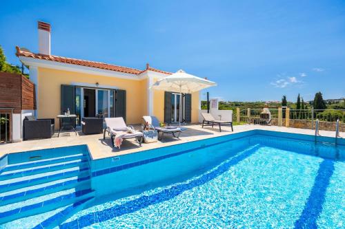 a swimming pool in front of a villa at Europe Villa Io in Fokáta