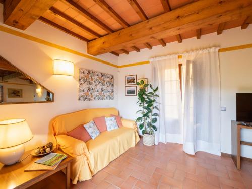 a living room with a couch and a table at Holiday Home La Corte by Interhome in Lucolena in Chianti