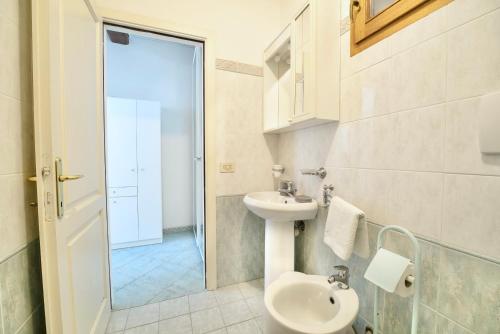 a bathroom with a sink and a toilet at Perfume House in Marciana