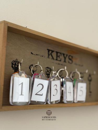 a shelf with keys and other items on it at Sapri Rooms in Lamezia Terme