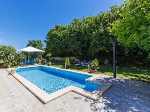 a swimming pool in a yard with a table at Holiday Home Pinezici-1 by Interhome in Marčana