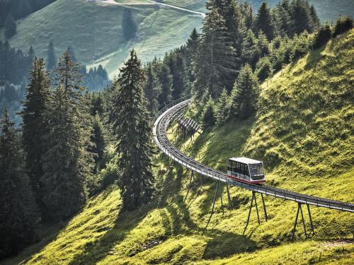 a train on a winding road on a mountain at Chalet Chalet 969 by Interhome in Moleson