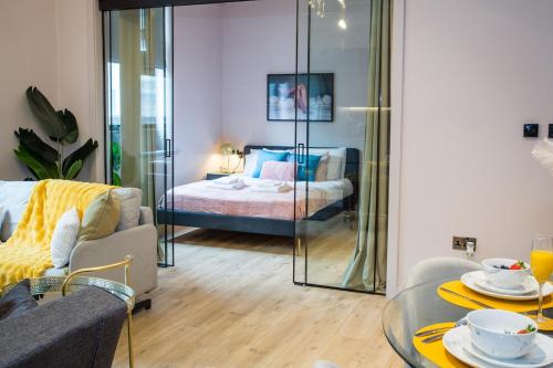 a living room with a table and a bed in a room at Chic Manchester Chinatown Stay - Shops & Nightlife in Manchester