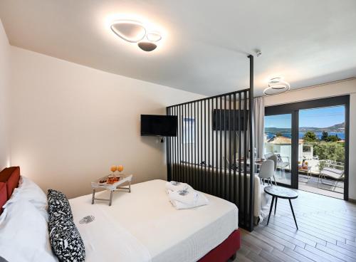 a hotel room with a bed and a balcony at Ionian Pearl Studio in Nikiana