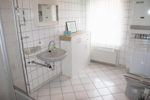 a bathroom with a sink and a toilet at Kirchblick an der Ostsee - ABC277 - nur Feriengäste! in Hohenkirchen