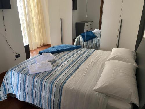a bedroom with a bed with two towels on it at Luca's Home in Villongo SantʼAlessandro