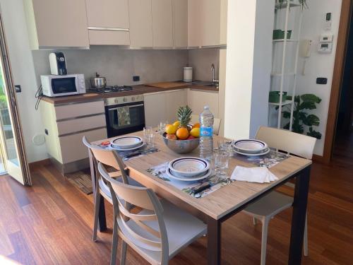 a kitchen with a table with a bowl of fruit on it at Luca's Home in Villongo SantʼAlessandro