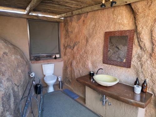 a bathroom with a sink and a toilet at Mowani Mountain Camp in Khorixas