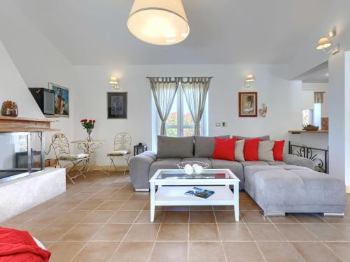 a living room with a couch and a table at Holiday Home Villa Samanta by Interhome in Momjan