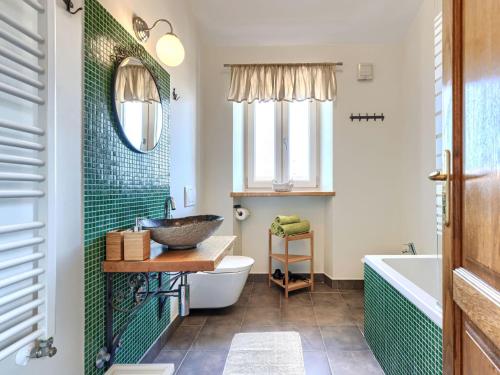 a bathroom with a sink and a toilet and a tub at Holiday Home Villa Samanta by Interhome in Momjan