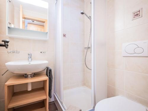 a bathroom with a sink and a shower at Apartment Rhodos B101 by Interhome in Ovronnaz
