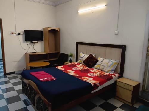 Postel nebo postele na pokoji v ubytování lakshmi inn lodge