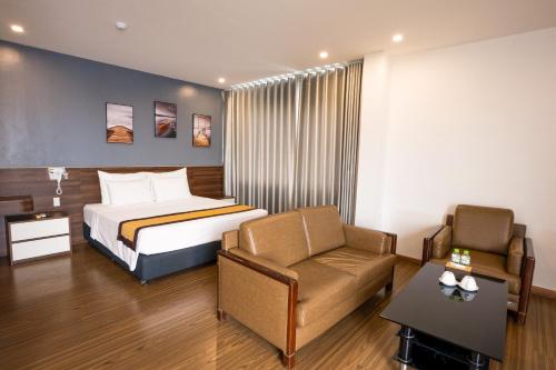 a hotel room with a bed and a chair at Kim Thanh Hotel, Vinh Phuc - Near Heron Lake Golf, Dam Vac in Vĩnh Phúc
