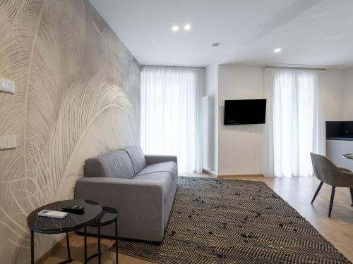 a living room with a couch and a table at Apartment Marconi by Interhome in Chiavenna