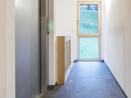 an empty hallway with a door and a window at Ferienwohnungen am Dollenberg in Bad Peterstal-Griesbach