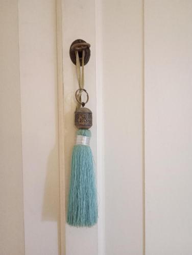 a blue tassel hanging on a door knob at Mansarda in Piazzetta Centro Storico in Manerba del Garda