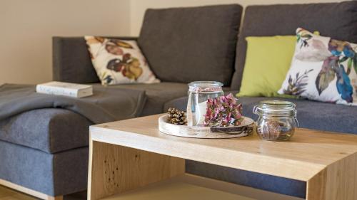 a living room with a couch and a coffee table at Ferienwohnungen am Dollenberg in Bad Peterstal-Griesbach