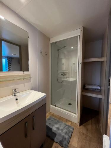 a bathroom with a glass shower and a sink at Quinta da Mariazinha in Fernao Ferro