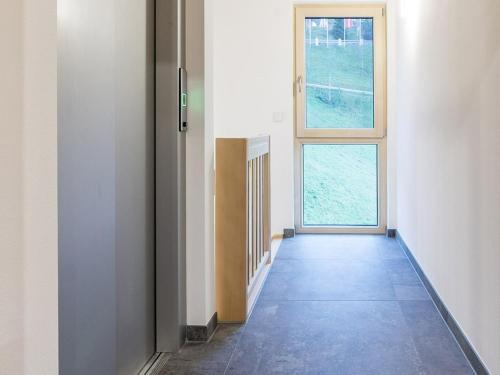 an empty hallway with a door and a window at Ferienwohnungen am Dollenberg in Bad Peterstal-Griesbach
